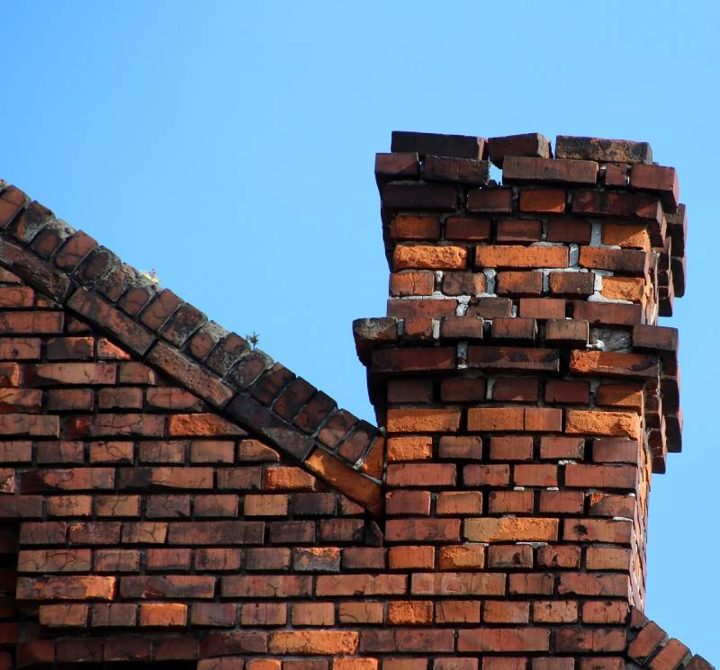 Damaged chimney on an Hillside home showing cracks and missing mortar